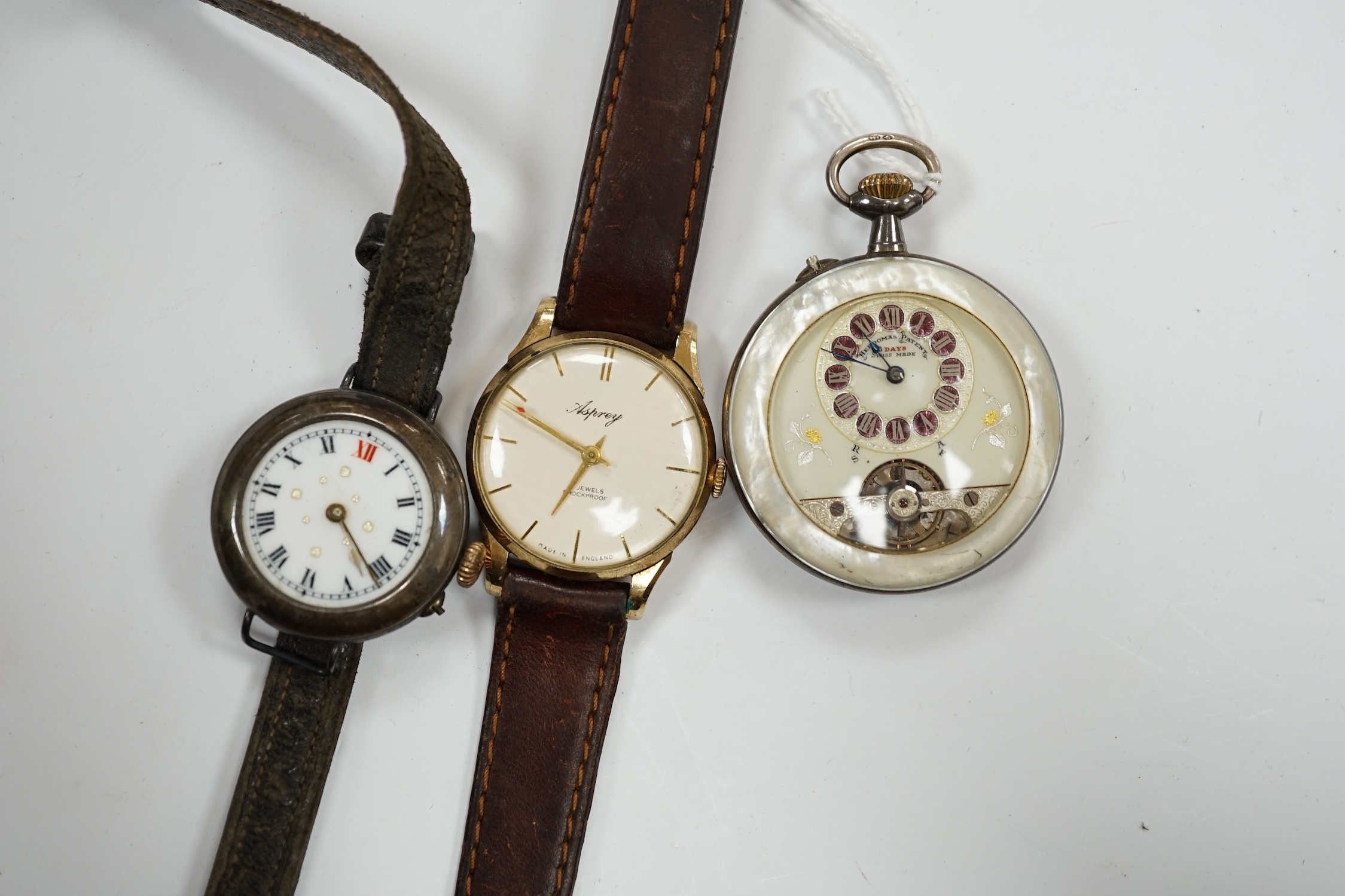A gentleman's 9ct gold manual wind wrist watch, retailed by Asprey, together with a silver wrist watch and a mother of pearl cased Hebdomas pocket watch. Condition - poor to fair